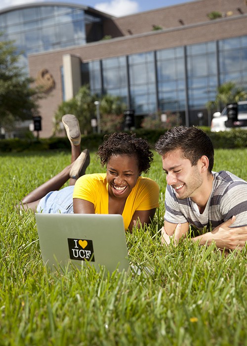 Two students in grass outside Career Services