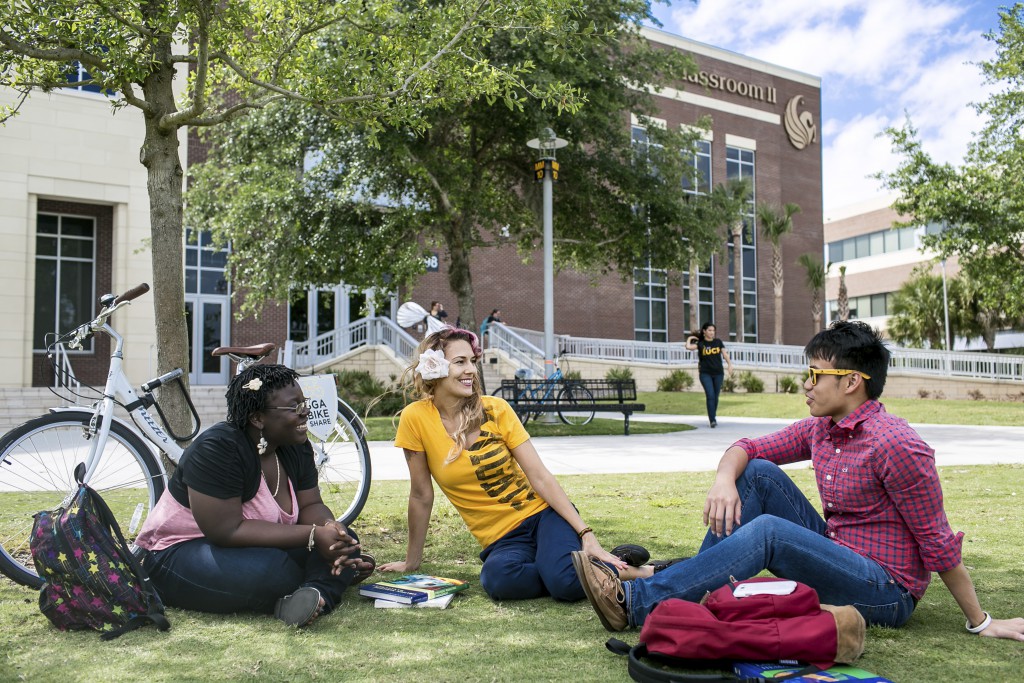 Unviersity of Central Florida, UCF, three students sitting on the grass