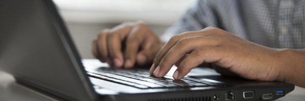 student typing on keyboard