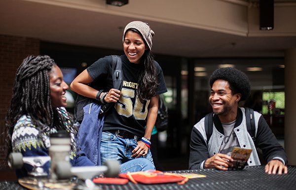 Campus Life A group of students have a conversation by the Washington Center.