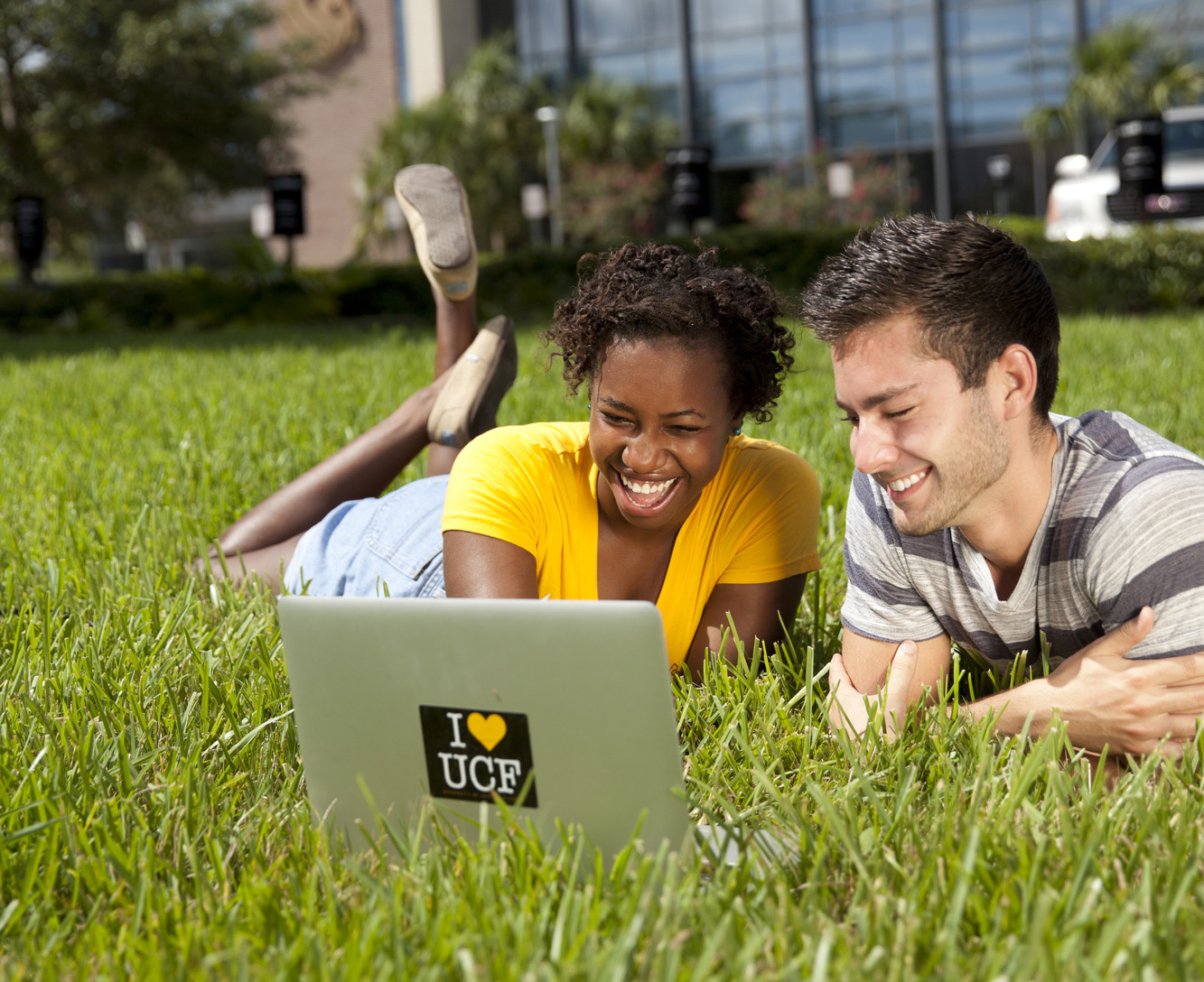 Two students in grass outside Career Services