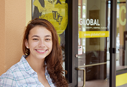 UCF Student in front of UCF Global Building