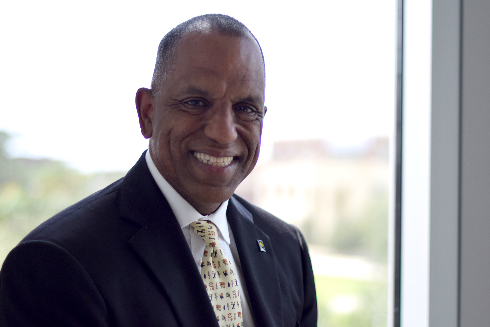 Dr. Barry Morris smiling while sitting in front of a sunlit window